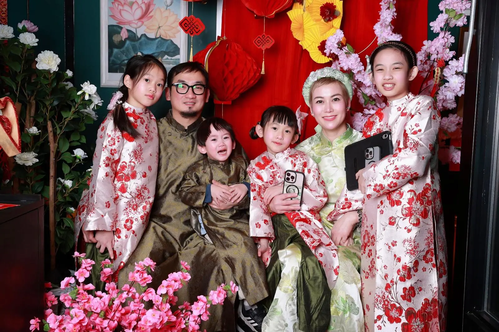 Chez Nguyen's family photo with laterns and flowers in Vietnamese New Year (Tet) theme with traditional dresses (ao dai)